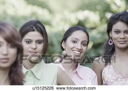 Stock Photograph - Portrait of two teenage girls with two young women. Fotosearch