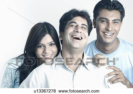 Stock Photo - Portrait of two young men and a young woman smiling. Fotosearch
