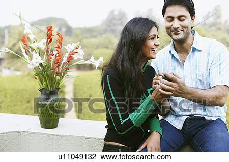 Close-up of a young couple holding a mobile phone View Large Photo Image Stock Image - Close-up of a young couple holding a mobile phone. Fotosearch