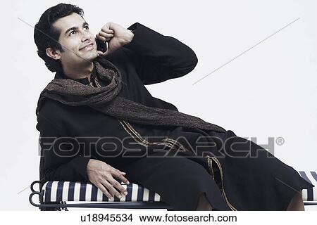 Picture - Close-up of a young man talking on a mobile phone. Fotosearch
