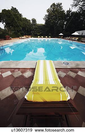 Stock Photo - Lounge chair at the poolside. Fotosearch
