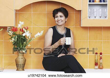 Mature woman holding a mug View Large Photo Image Picture - Mature woman holding a mug. Fotosearch