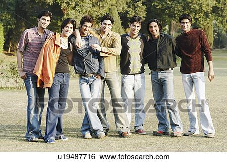 Stock Photograph - Portrait of a group of young men standing in the garden. Fotosearch