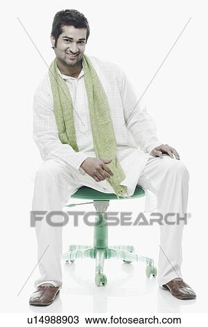 Portrait of a young man sitting on a chair View Large Photo Image Stock Image - Portrait of a young man sitting on a chair. Fotosearch