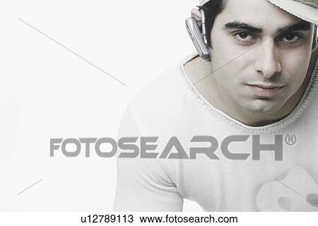 Portrait of a young man wearing a hands free device View Large Photo Image Stock Image - Portrait of a young man wearing a hands free device. Fotosearch
