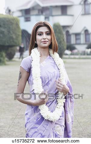 Portrait of a young woman wearing a garland View Large Photo Image Stock Image - Portrait of a young woman wearing a garland. Fotosearch