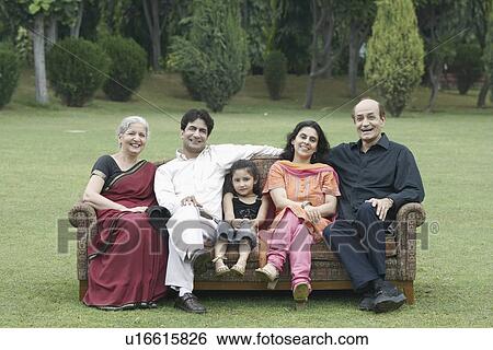 Portrait of parents with their children and their granddaughter sitting outdoors on a couch View Large Photo Image Stock Photograph - Portrait of parents with their children and their granddaughter sitting outdoors on a couch. Fotosearch