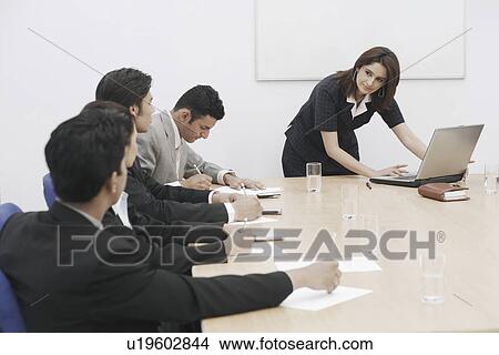 Picture - Businesswoman giving a presentation. Fotosearch