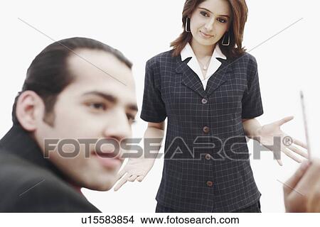 Picture - Businesswoman looking at a businessman. Fotosearch