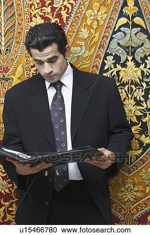 Close-up of a businessman reading a file View Large Photo Image Stock Image - Close-up of a businessman reading a file. Fotosearch