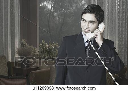 Close-up of a businessman talking on the telephone View Large Photo Image Stock Photo - Close-up of a businessman talking on the telephone. Fotosearch