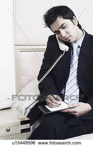 Stock Photograph - Close-up of a businessman talking on the telephone. Fotosearch