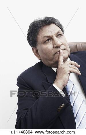 Close-up of a businessman with his finger on his lips View Large Photo Image Picture - Close-up of a businessman with his finger on his lips. Fotosearch