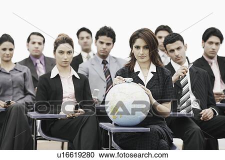 Group of business executives sitting in a meeting View Large Photo Image Stock Image - Group of business executives sitting in a meeting. Fotosearch
