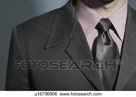 Mid section view of a businessman View Large Photo Image Stock Photograph - Mid section view of a businessman. Fotosearch