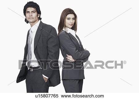 Portrait of a businessman and a businesswoman standing back to back View Large Photo Image Stock Photography - Portrait of a businessman and a businesswoman standing back to back. Fotosearch
