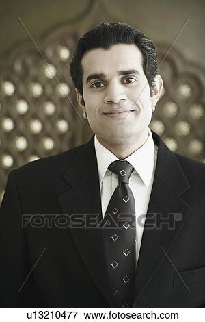 Portrait of a businessman smiling View Large Photo Image Stock Photo - Portrait of a businessman smiling. Fotosearch