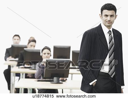 Portrait of a businessman standing in an office View Large Photo Image Stock Photography - Portrait of a businessman standing in an office. Fotosearch