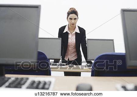 Portrait of a businesswoman leaning against the table View Large Photo Image Stock Photo - Portrait of a businesswoman leaning against the table. Fotosearch