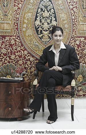Portrait of a businesswoman sitting in an armchair View Large Photo Image Stock Image - Portrait of a businesswoman sitting in an armchair. Fotosearch