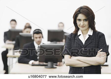 Portrait of a businesswoman standing in an office View Large Photo Image Stock Photo - Portrait of a businesswoman standing in an office. Fotosearch