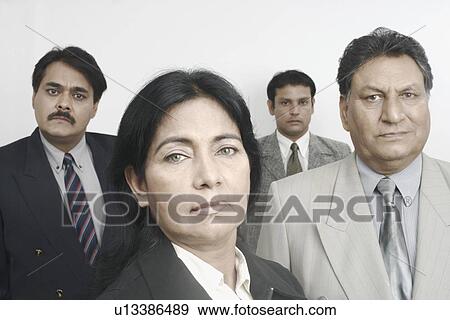 Portrait of a businesswoman with three businessmen behind her View Large Photo Image Stock Photo - Portrait of a businesswoman with three businessmen behind her. Fotosearch