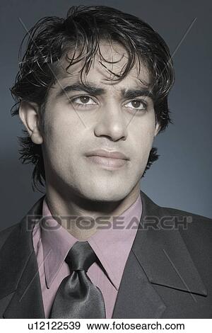 Stock Photo - Close-up of a businessman looking away. Fotosearch