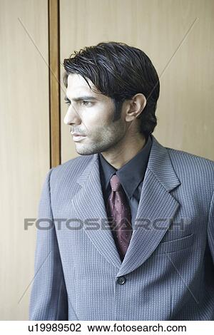 Close-up of a businessman looking sideways View Large Photo Image Stock Image - Close-up of a businessman looking sideways. Fotosearch