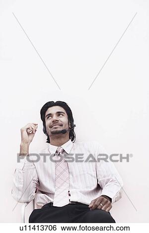 Close-up of a businessman wearing a hands free device View Large Photo Image Stock Photograph - Close-up of a businessman wearing a hands free device. Fotosearch
