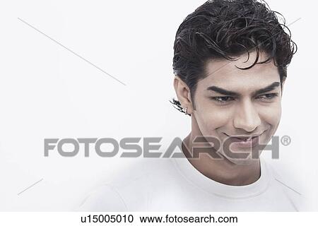 Close-up of a young man smiling View Large Photo Image Stock Image - Close-up of a young man smiling. Fotosearch
