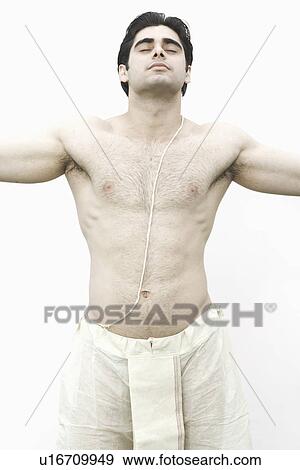 Stock Photo - Close-up of a young man standing with his arms outstretched. Fotosearch