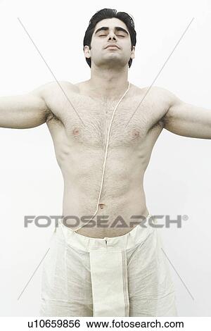 Close-up of a young man standing with his arms outstretched View Large Photo Image Stock Photograph - Close-up of a young man standing with his arms outstretched. Fotosearch