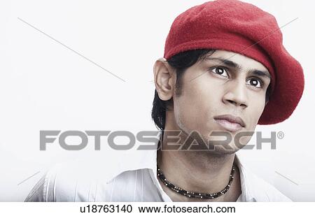 Stock Image - Close-up of a young man wearing a cap. Fotosearch