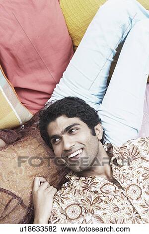 High angle view of a young man lying on a woman's lap View Large Photo Image Stock Image - High angle view of a young man lying on a woman's lap. Fotosearch