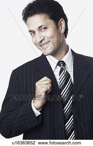 Portrait of a businessman smiling View Large Photo Image Stock Image - Portrait of a businessman smiling. Fotosearch
