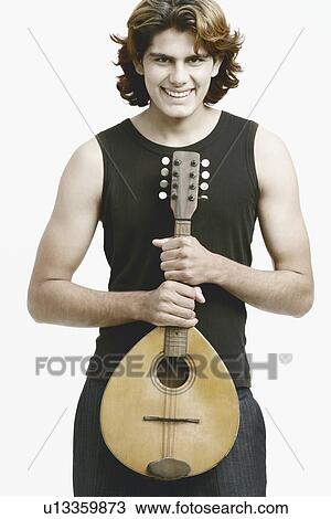 Portrait of a male musician holding a banjo View Large Photo Image Stock Image - Portrait of a male musician holding a banjo. Fotosearch