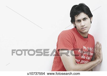 Portrait of a young man leaning against a wall View Large Photo Image Picture - Portrait of a young man leaning against a wall. Fotosearch