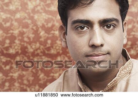 Stock Image - Portrait of a young man looking serious. Fotosearch
