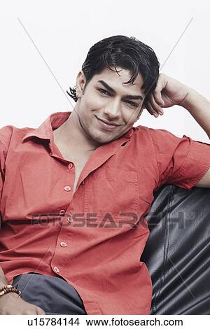 Portrait of a young man sitting View Large Photo Image Picture - Portrait of a young man sitting. Fotosearch