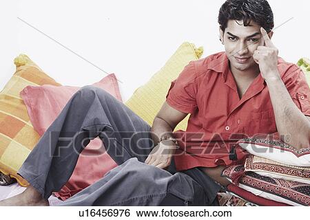 Portrait of a young man smiling View Large Photo Image Stock Photograph - Portrait of a young man smiling. Fotosearch