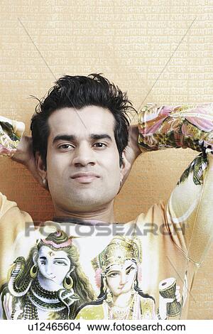 Portrait of a young man with hands behind his head View Large Photo Image Picture - Portrait of a young man with hands behind his head. Fotosearch