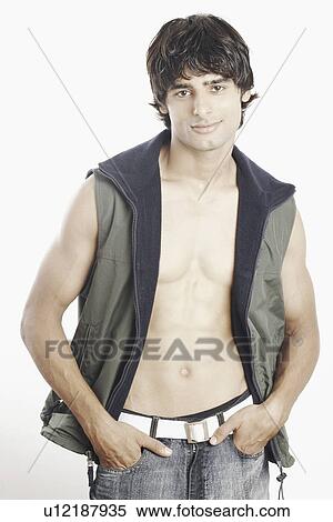 Portrait of a young man with his hands in his pockets View Large Photo Image Stock Photography - Portrait of a young man with his hands in his pockets. Fotosearch