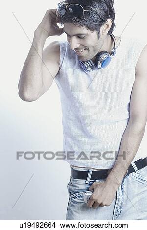 Young man looking down smiling View Large Photo Image Picture - Young man looking down smiling. Fotosearch