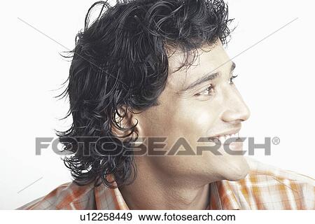 Young man looking sideways View Large Photo Image Stock Photo - Young man looking sideways. Fotosearch