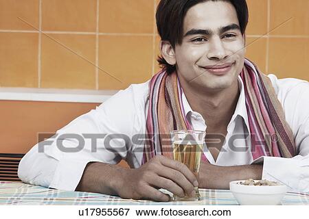 Stock Photo - Close-up of a young man holding a beer stein. Fotosearch