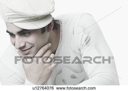 Close-up of a young man with his hand on his chin View Large Photo Image Stock Photograph - Close-up of a young man with his hand on his chin. Fotosearch