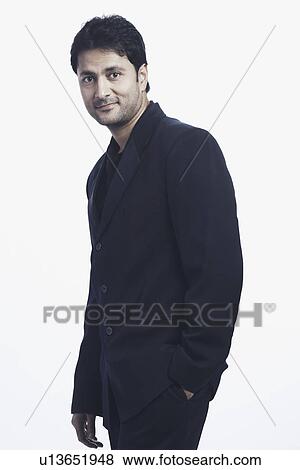 Stock Photo - Portrait of a mid adult man with his hands in his pockets. Fotosearch