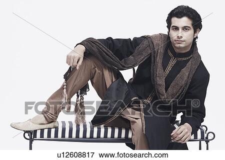 Portrait of a young man sitting on a bench View Large Photo Image Stock Photo - Portrait of a young man sitting on a bench. Fotosearch