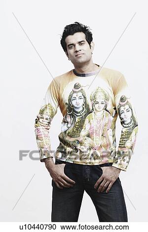Portrait of a young man standing with his hands in his pockets View Large Photo Image Stock Image - Portrait of a young man standing with his hands in his pockets. Fotosearch
