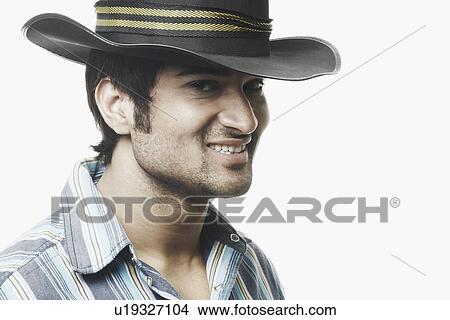 Picture - Portrait of a young man wearing a hat smiling. Fotosearch